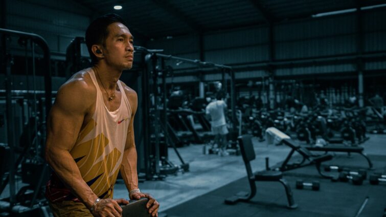 muscle recovery after training cover image with a lifter resting beside a simple weekly routine checklist