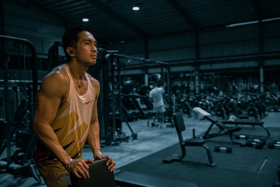 muscle recovery after training cover image with a lifter resting beside a simple weekly routine checklist